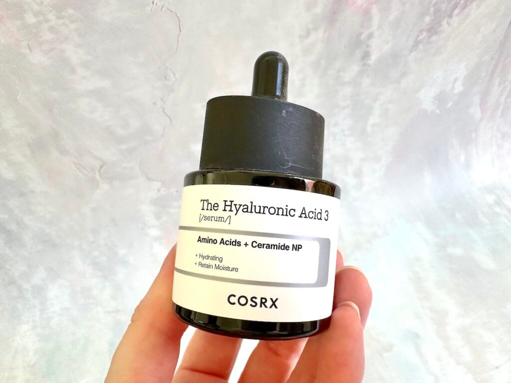 COSRX The Hyaluronic Acid 3 Serum with Amino Acids + Ceramide NP, handheld.