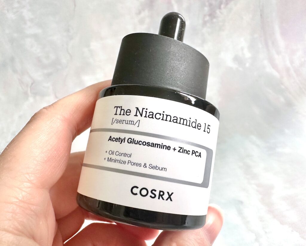 COSRX The Niacinamide 15 Serum, handheld.