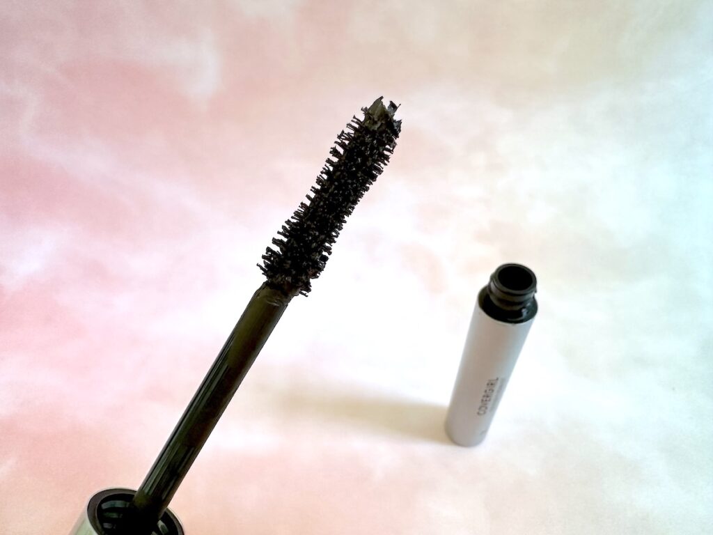 CoverGirl Exhibitionist Mascara in the shade Black Brown. Mascara wand and open tube.