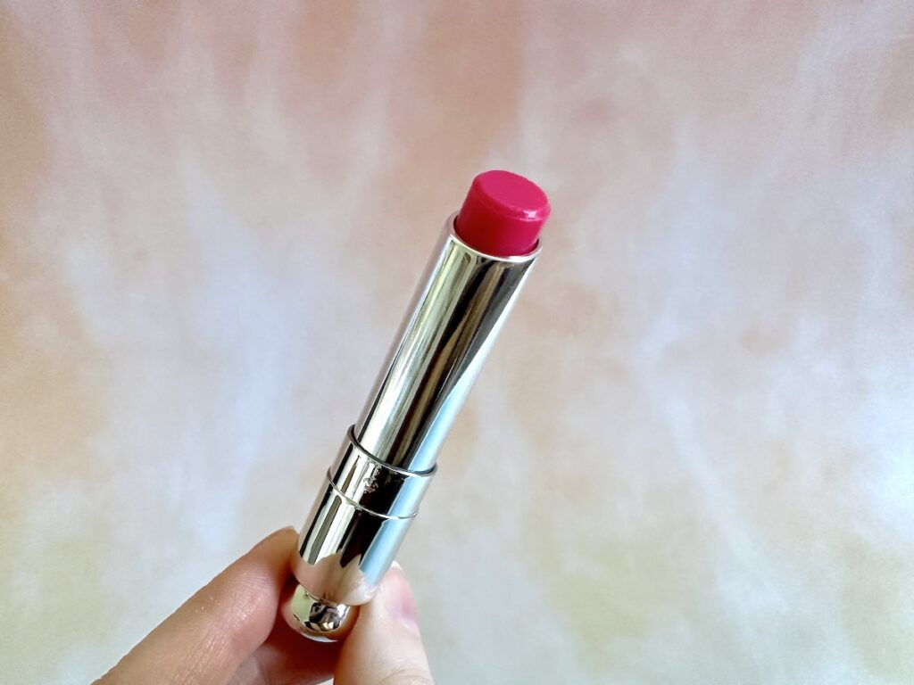 Dior Addict Lip Glow in the shade Raspberry, handheld.