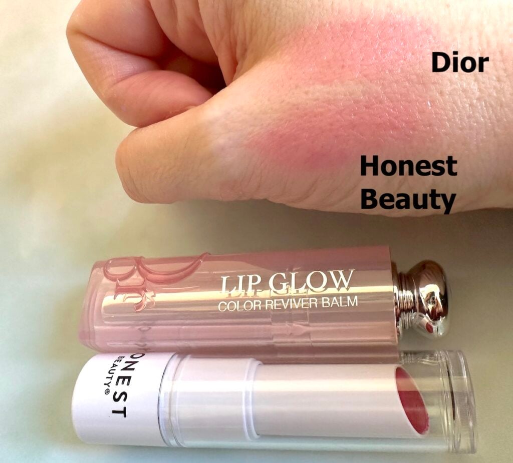 Dior Lip Glow in Raspberry and Honest Beauty Tinted Lip Balm in the shade Dragon Fruit sampled on hand.