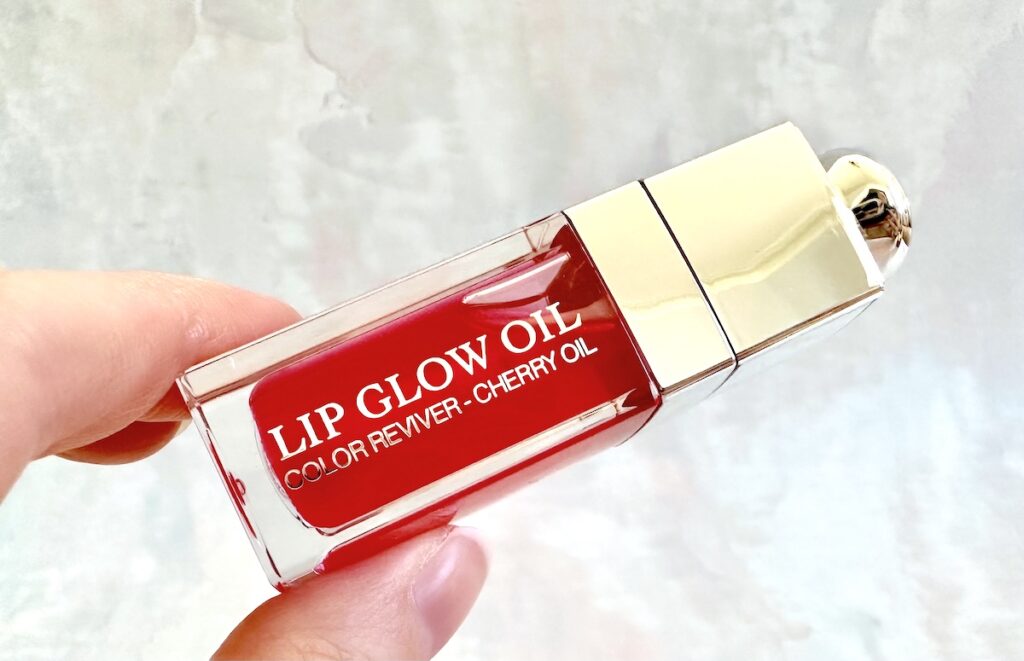 Dior Lip Glow Oil in Cherry, handheld.