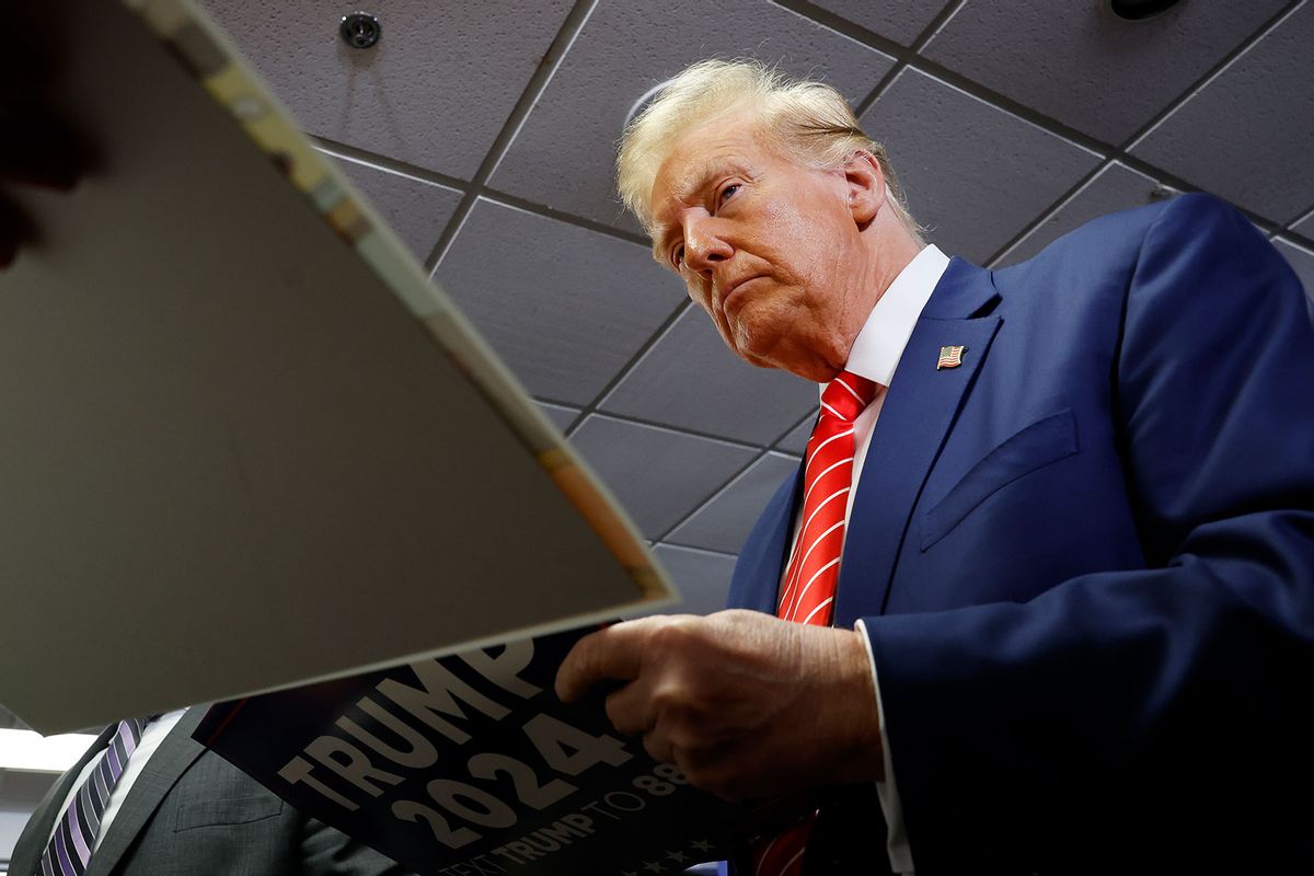 Republican presidential candidate, former U.S. President Donald Trump signs autographs for guests after speaking at his campaign event on January 06, 2024 in Newton, Iowa. (Anna Moneymaker/Getty Images)