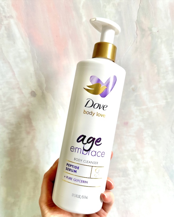 Dove Age Embrace Body Cleanser body wash, handheld.