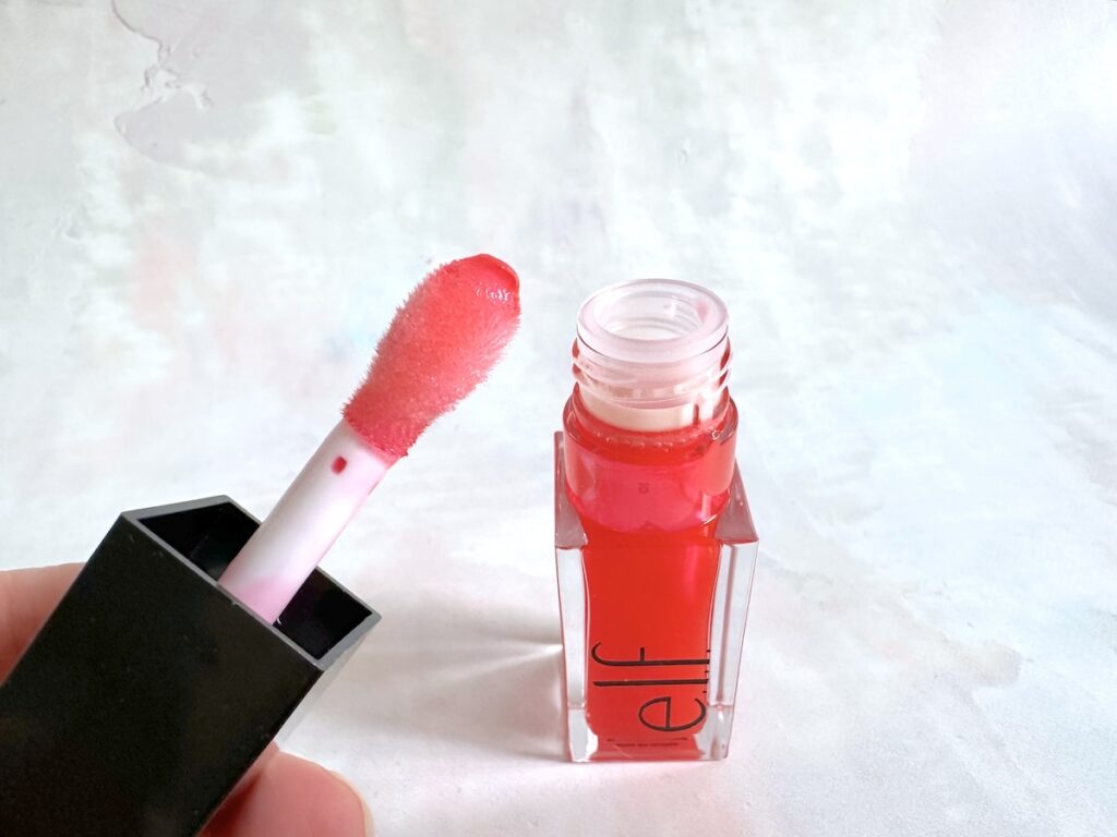 e.l.f. Glow Reviver Lip Oil in the shade Red Delicious, open tube with extra large applicator.