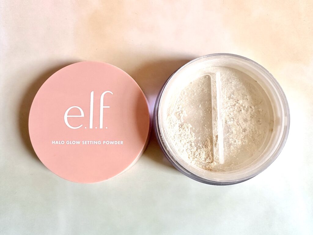 e.l.f. Halo Glow Setting Powder in the shade Light, open jar with lid.