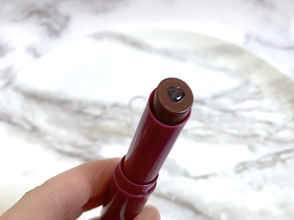 elf Hydrating Lip Shine in the shade Ecstatic lid removed to show hydrating core.