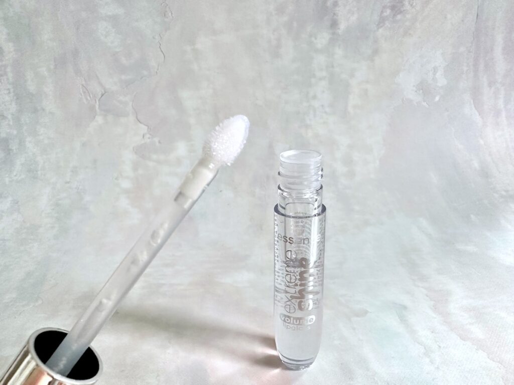 Essence Extreme Shine Volume Lip Gloss in the shade Crystal Clear, open tube with applicator wand.