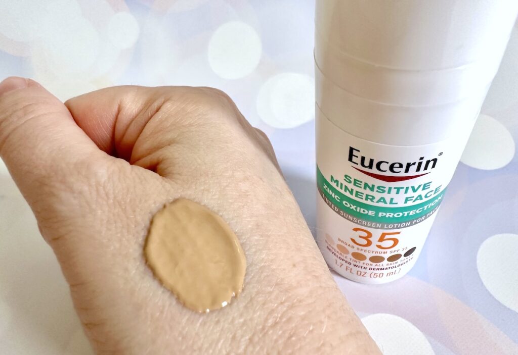 Eucerin Sensitive Tinted Mineral Face Sunscreen SPF 35 bottle next to sample on hand.