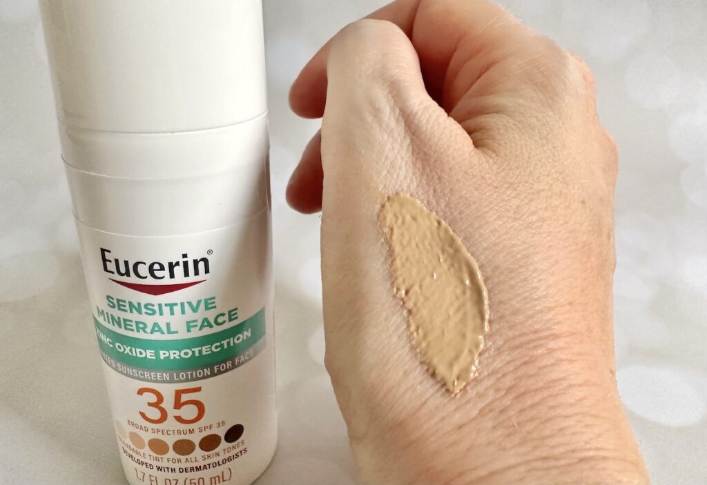 Eucerin Sensitive Tinted Mineral Face Lotion SPF 35, bottle next to sample on hand.