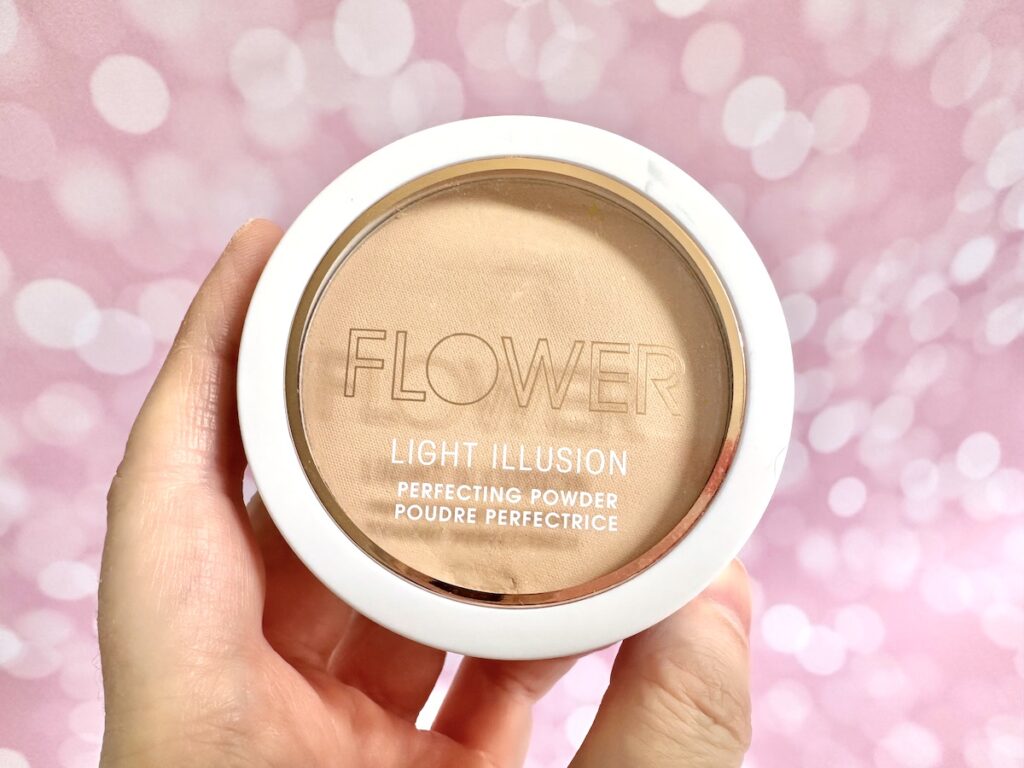 Flower Beauty Light Illusion Perfecting Powder in the shade Beige, handheld.