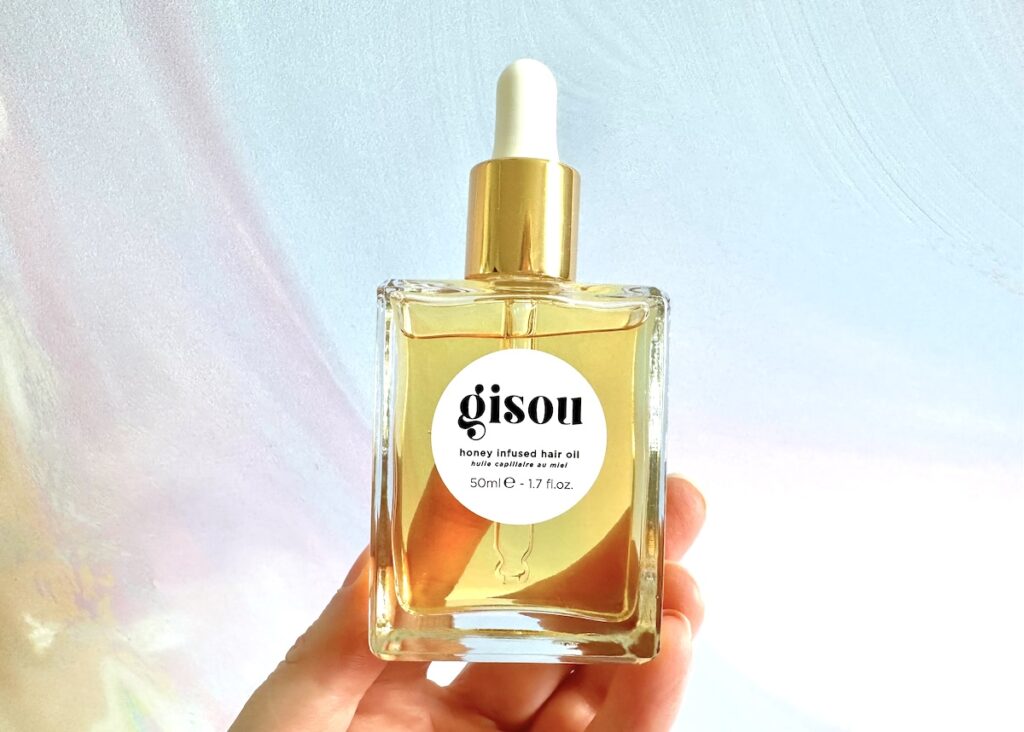 Gisou Honey Infused Hair Oil, handheld.