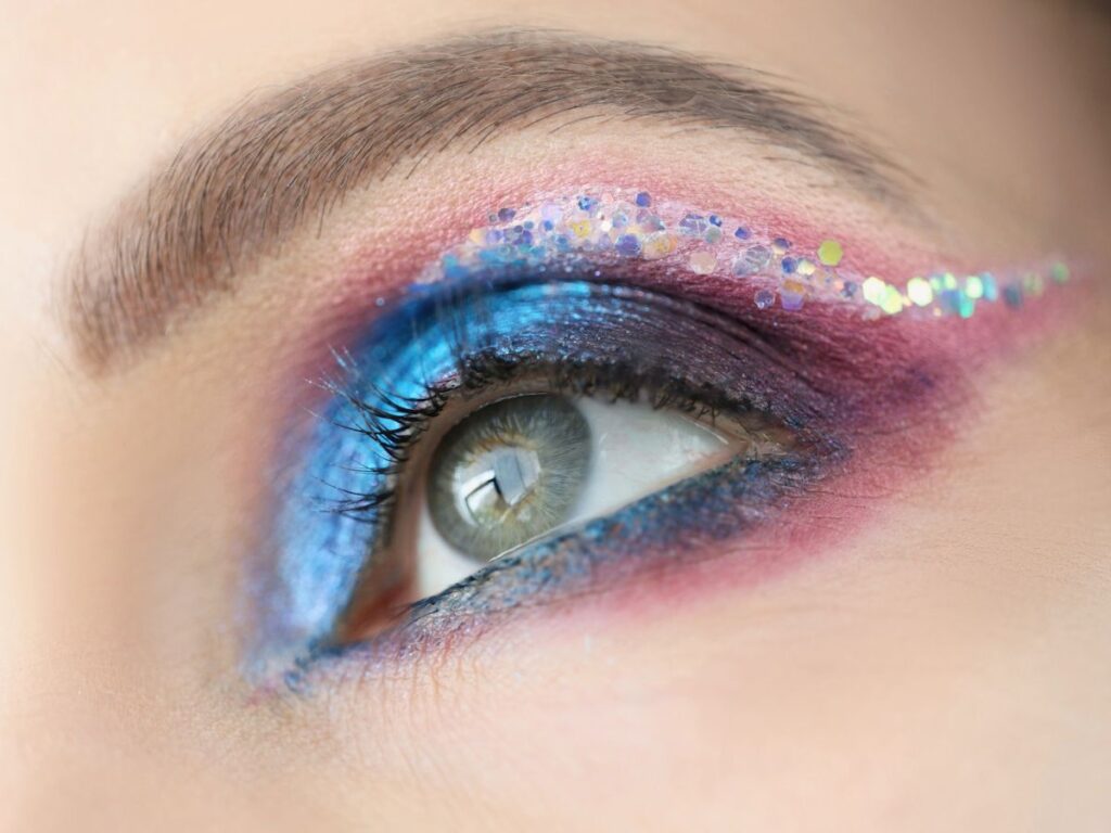 Pink and blue glitter eyeshadow look.