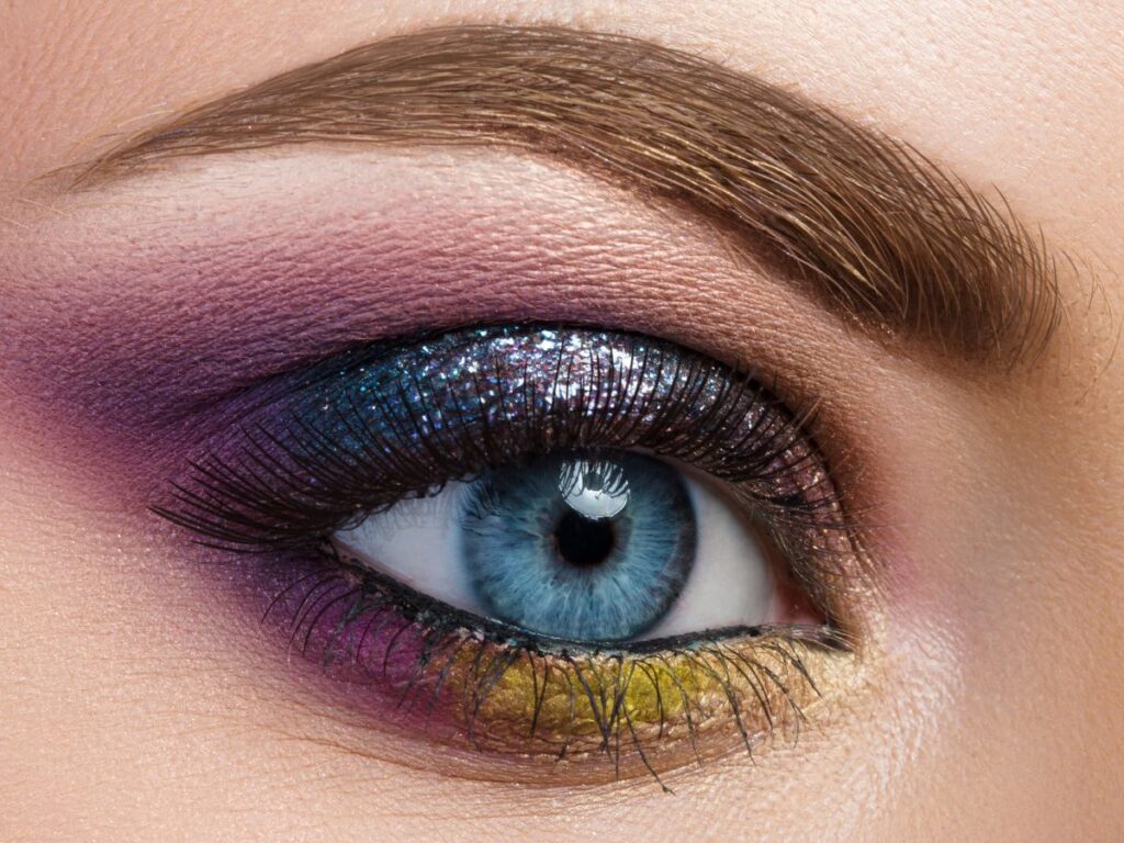 Gold, blue and purple glittery shadow look.