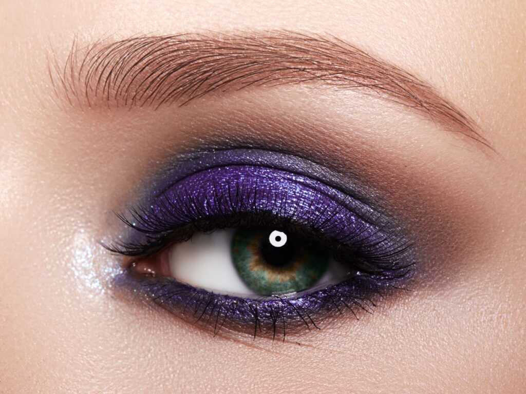 Metallic purple eyeshadow that blends to a deep gray on eye.