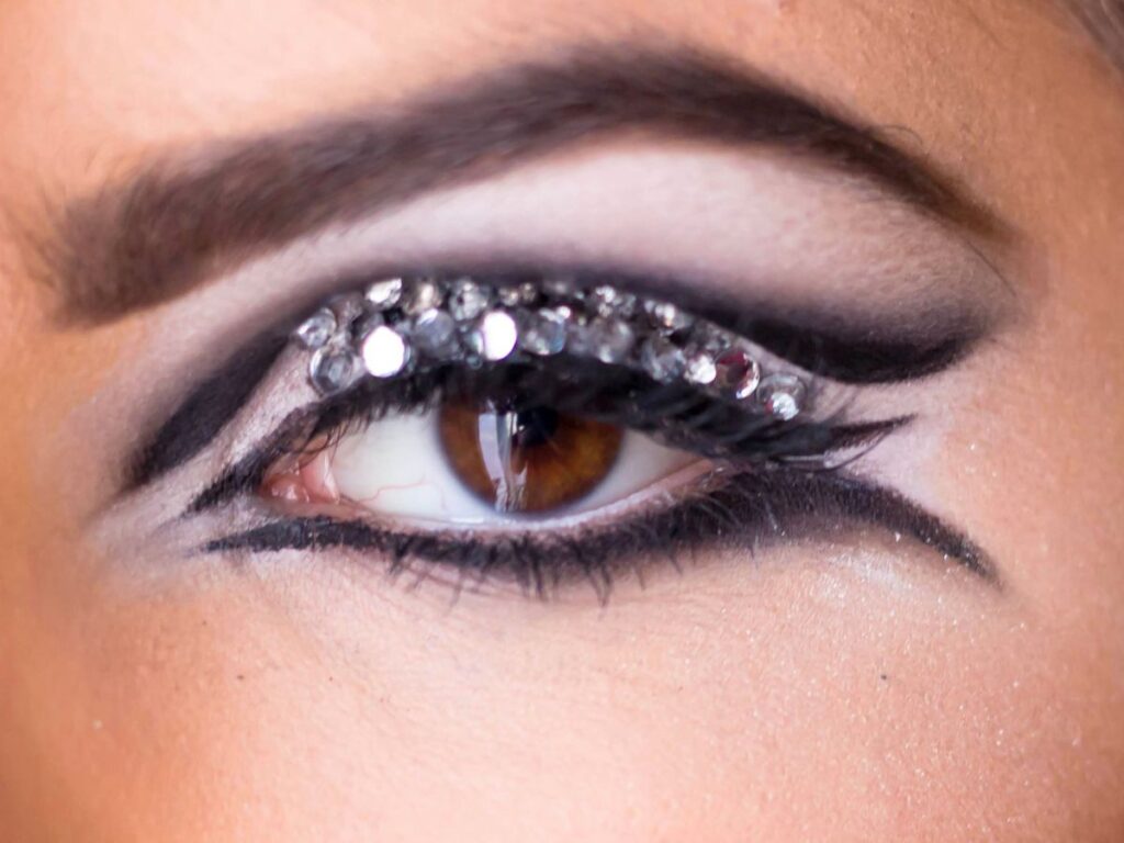 Dramatic winged silver and black eyeshadow and liner makeup look.