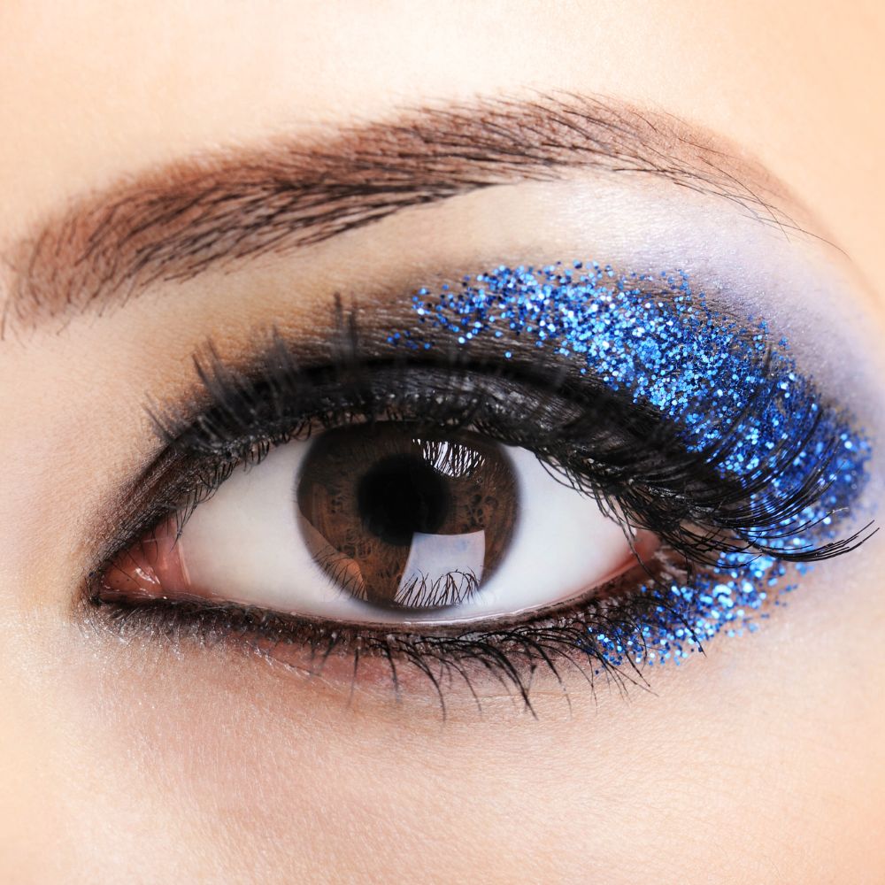 Blue glitter eyeshadow look on brown eyes.