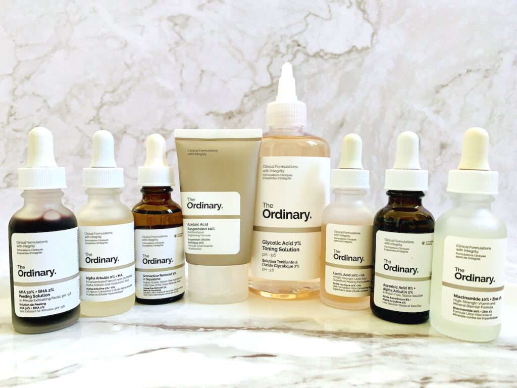 The Ordinary skincare products on marble background.