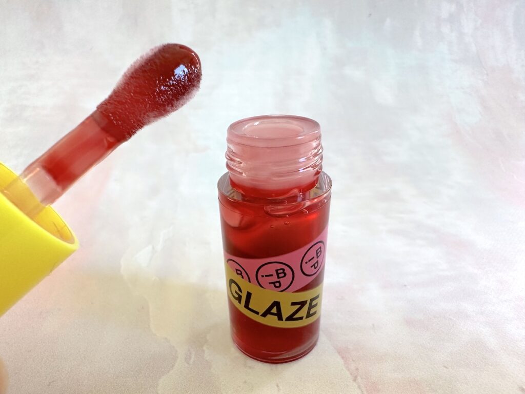 iNNBEAUTY PROJECT Glaze Lip Oil in the shade Glaze #1 Candy Apple, open with dropper.