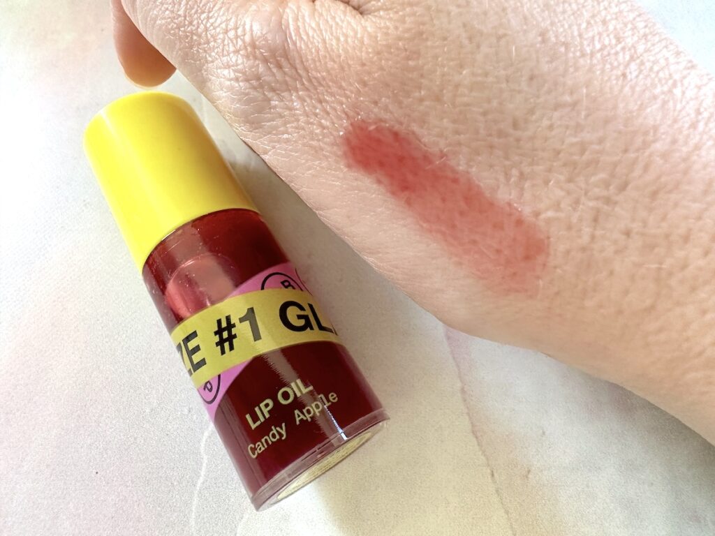 iNNBEAUTY PROJECT Glaze Lip Oil in the shade Glaze #1 Candy Apple, sampled on hand.