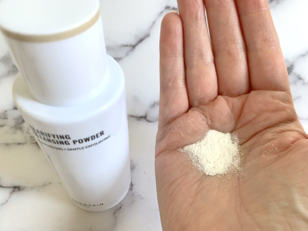 Juno & Co Clarifying Cleansing Powder sampled on palm of hand.