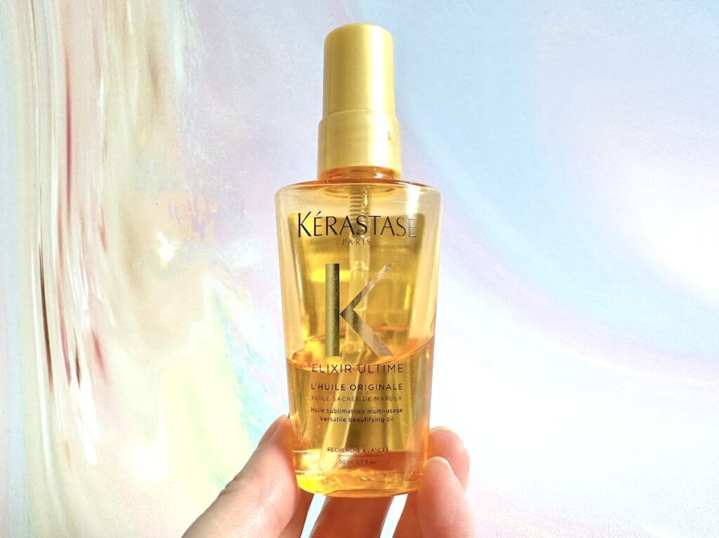 Kerastase Elixir Ultime Hair Oil, handheld.