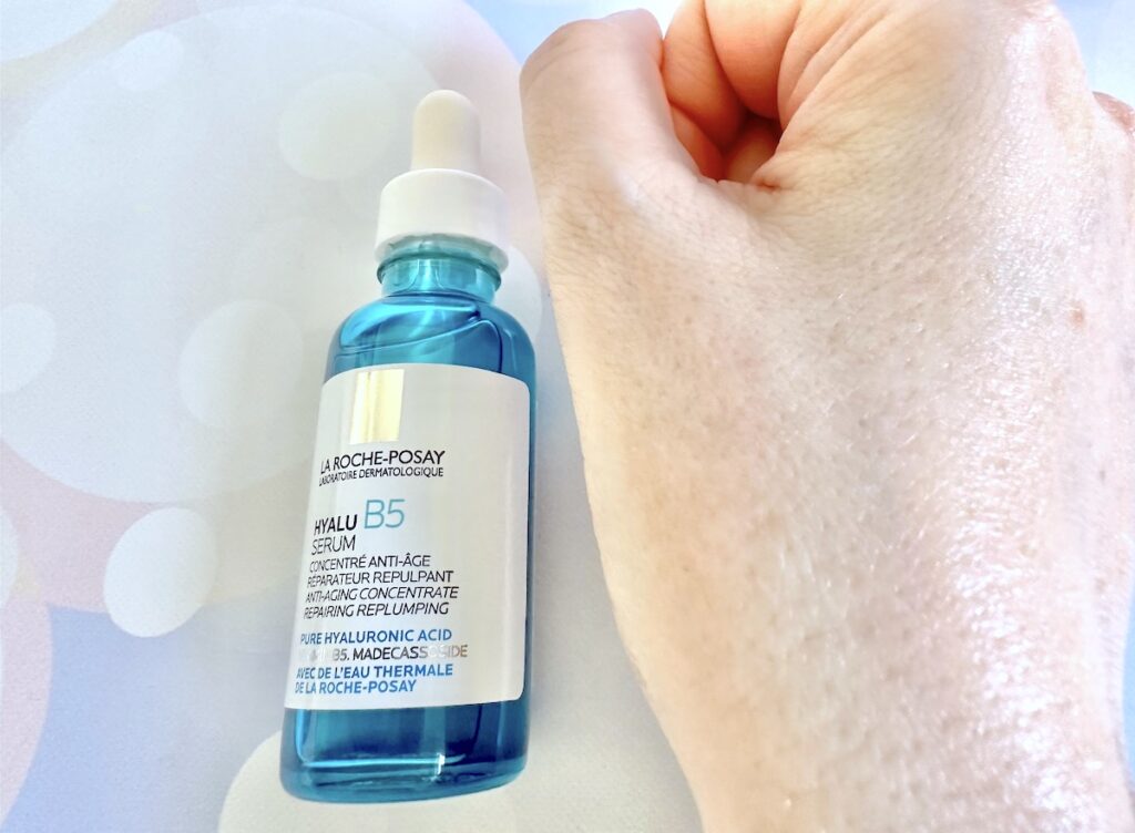 La Roche-Posay Hyalu B5 Serum, flatlay of bottle next to sample absorbed into hand.