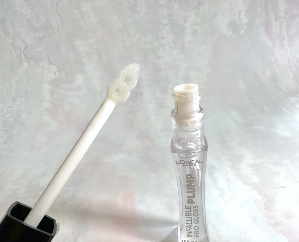 L'Oreal Infallible Pro Lip Gloss Plump, open tube with applicator wand.