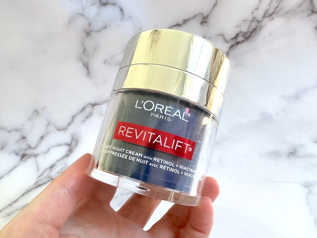 L'Oreal Revitalift Pressed Night Cream With Retinol + Niacinamide handheld.