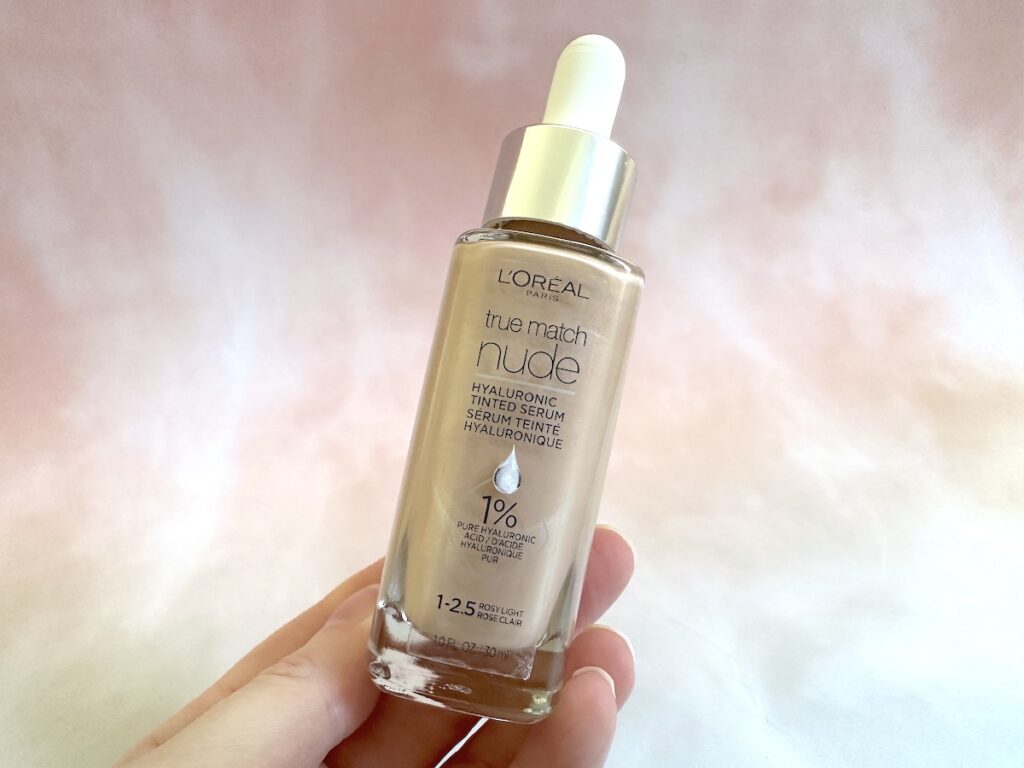 L'Oreal True Match Nude Hyaluronic Tinted Serum Foundation handheld in the shade Rosy Light.