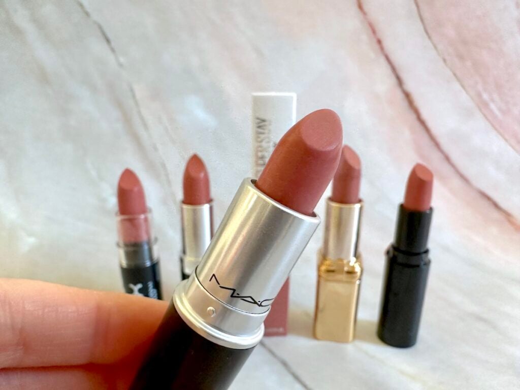 MAC Velvet Teddy Matte Lipstick handheld in front of dupes from NYX, Maybelline, Rimmel London, L'Oreal and Wet n Wild.