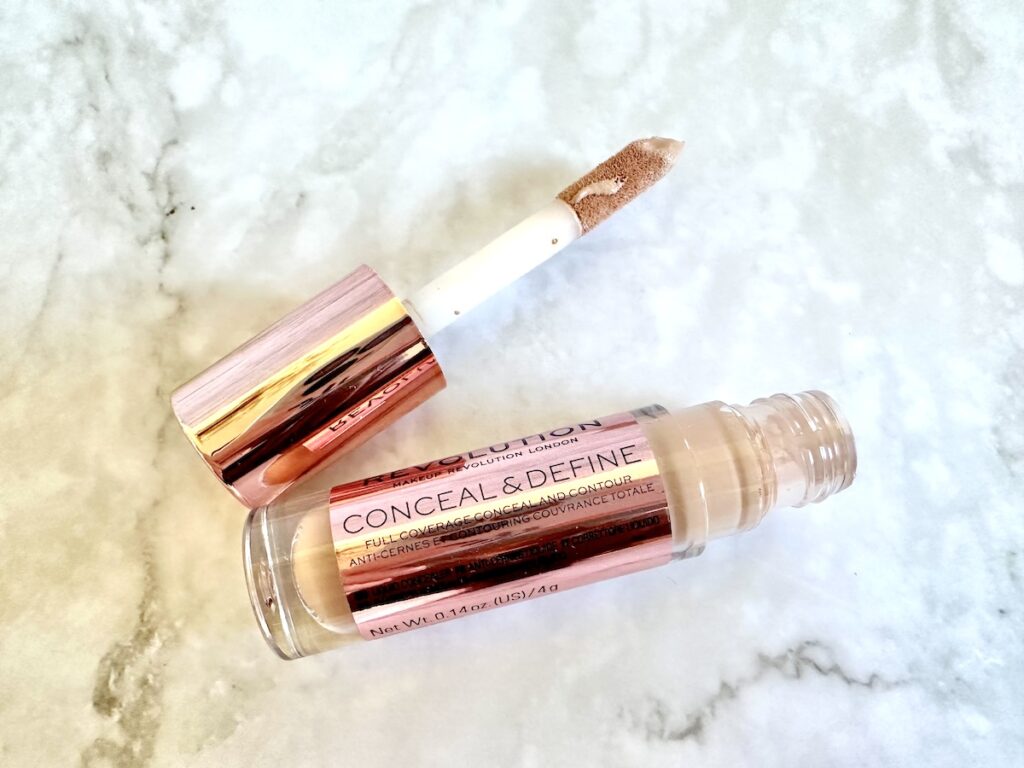 Makeup Revolution Conceal & Define Full Coverage Concealer in the shade C4, flataly of open tube with large doe-foot applicator.