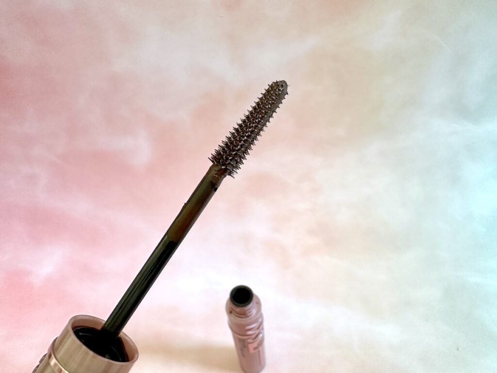 Maybelline Lash Sensational Sky High Mascara wand and open tube in background.