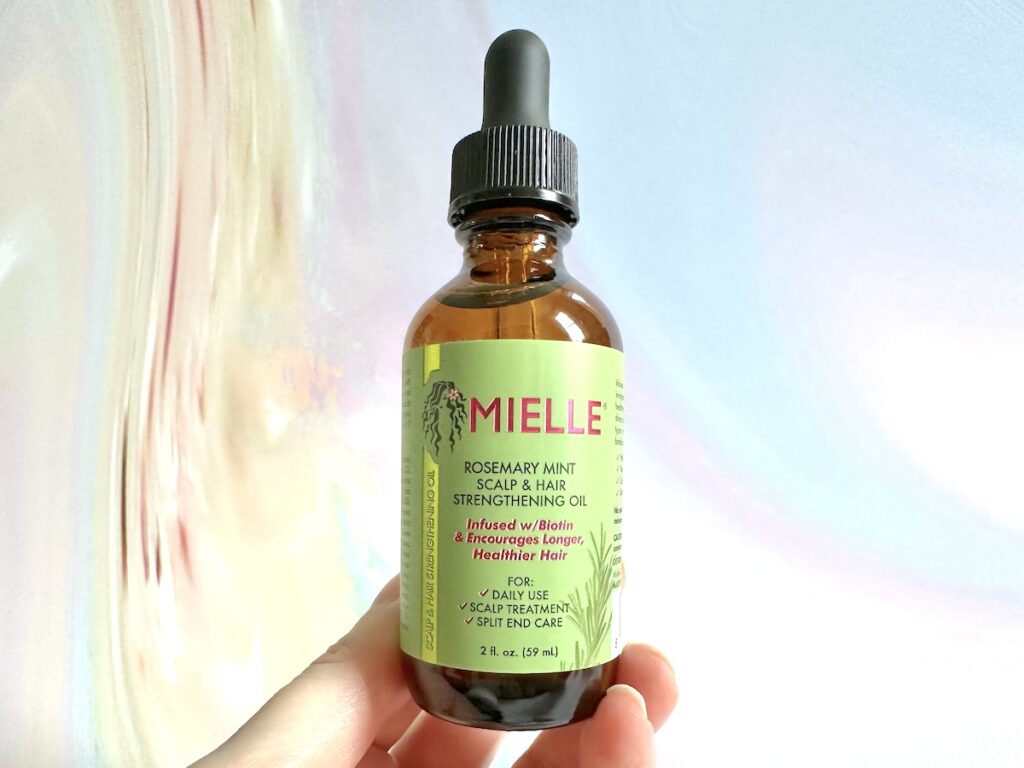 Mielle Organics Rosemary Mint Scalp & Hair Strengthening Oil, handheld.