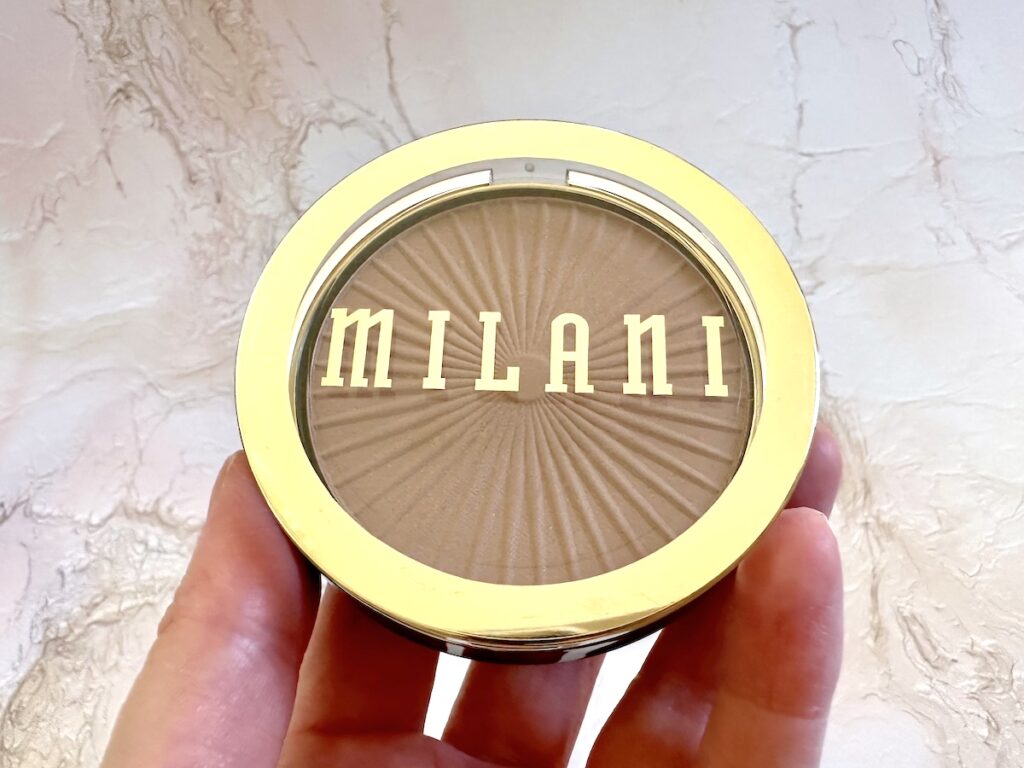 Milani Silky Matte Bronzing Powder in the shade Sun Kissed, handheld.