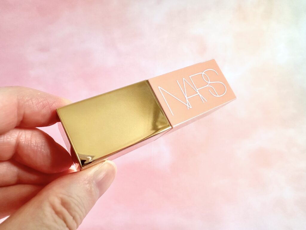 NARS Afterglow Liquid Blush in the shade Orgasm, handheld.