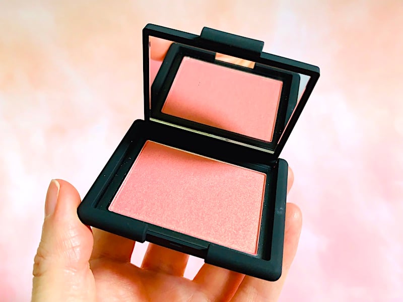 Hand holding Nars Orgasm Blush