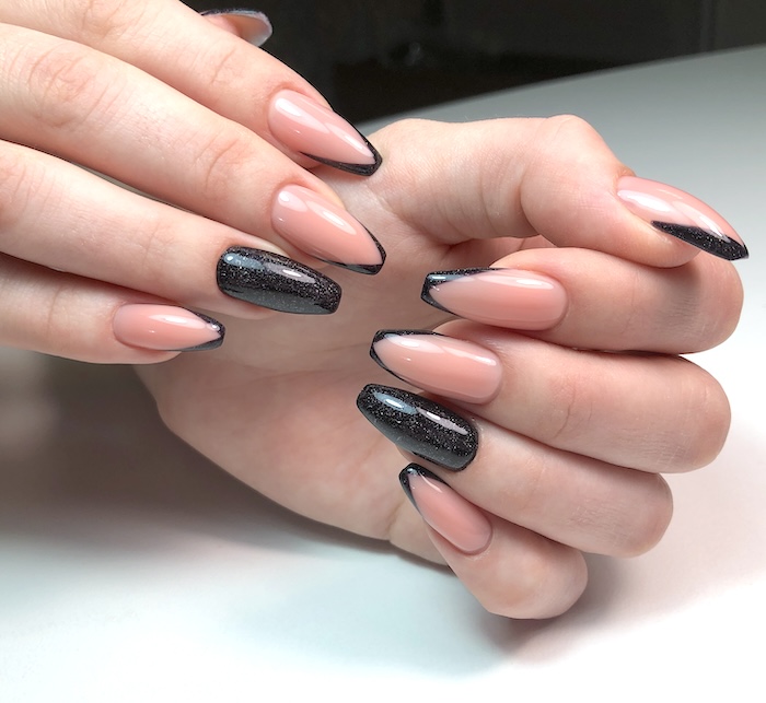 Nude black French manicure nails.