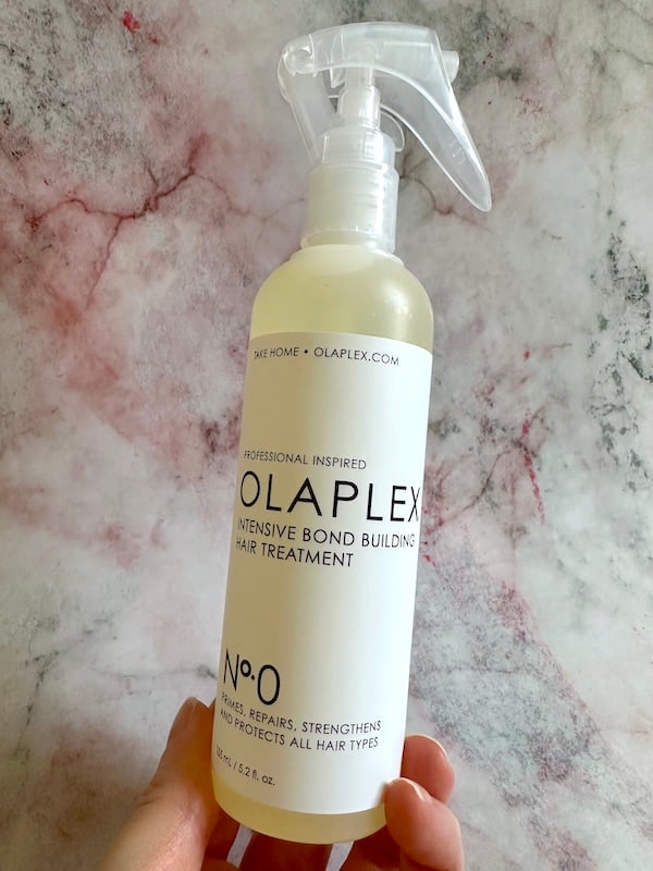 Olaplex No.0 Intensive Bond Building Treatment handheld.