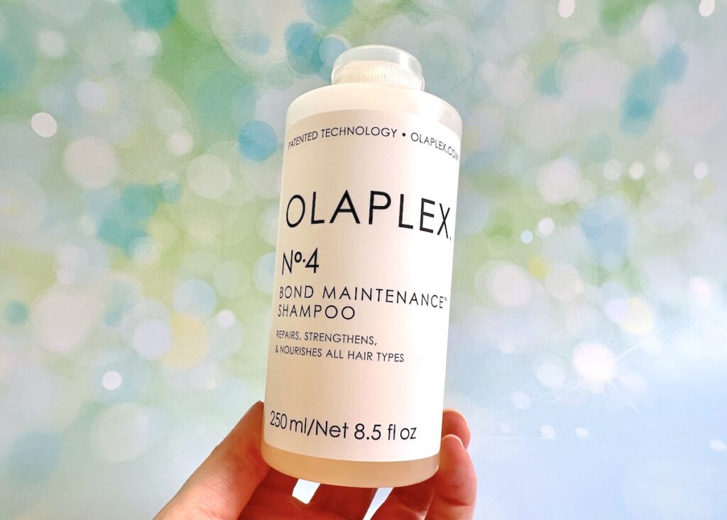 Olaplex No.4 Bond Maintenance Shampoo, handheld.