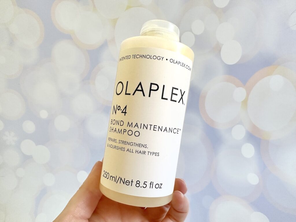 Olaplex No. 4 Bond Maintenance Shampoo, handheld.