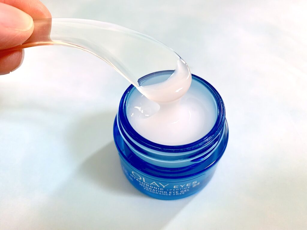 Olay Hyaluronic + Peptide 24 Hydrating Eye Gel open and sampled with clear spatula.