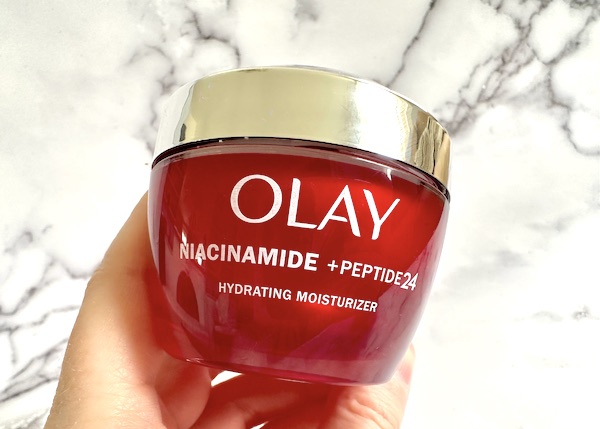 Olay Niacinamide + Peptide 24 Moisturizer, handheld.