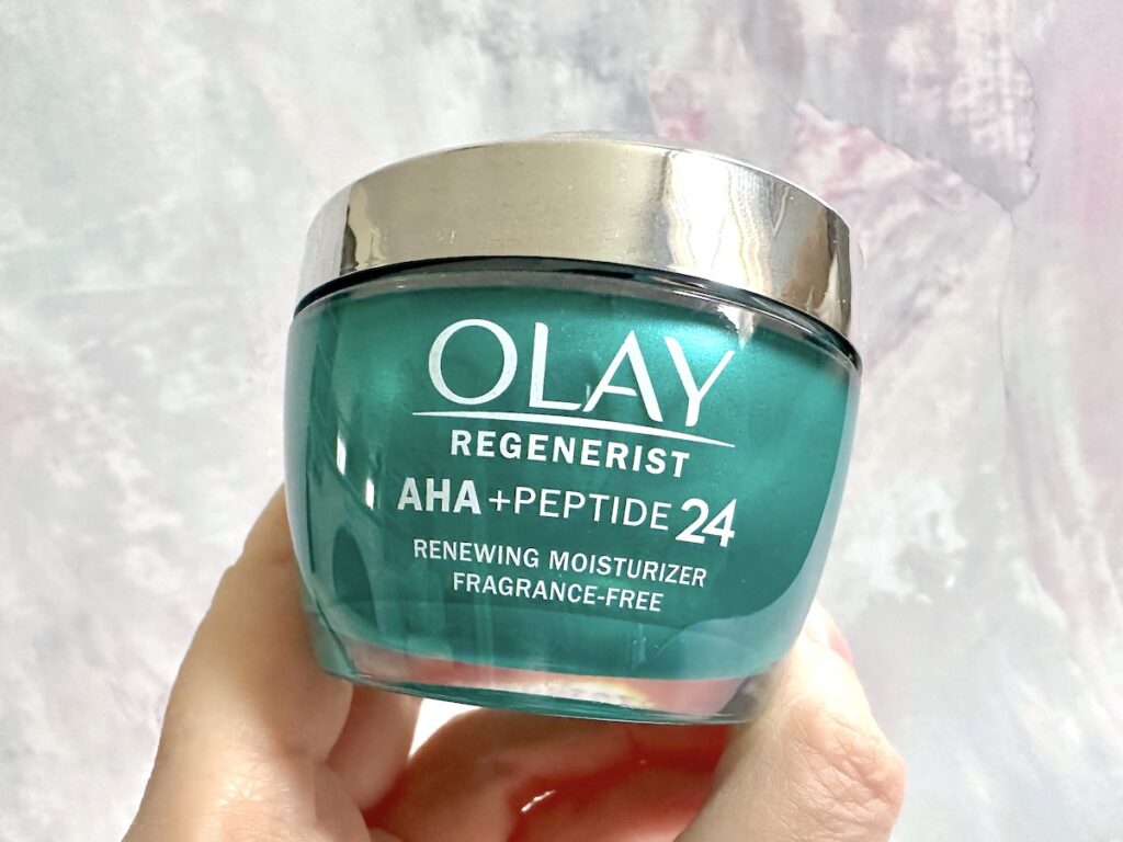 Olay AHA + Peptide 24 Face Moisturize, handheld.