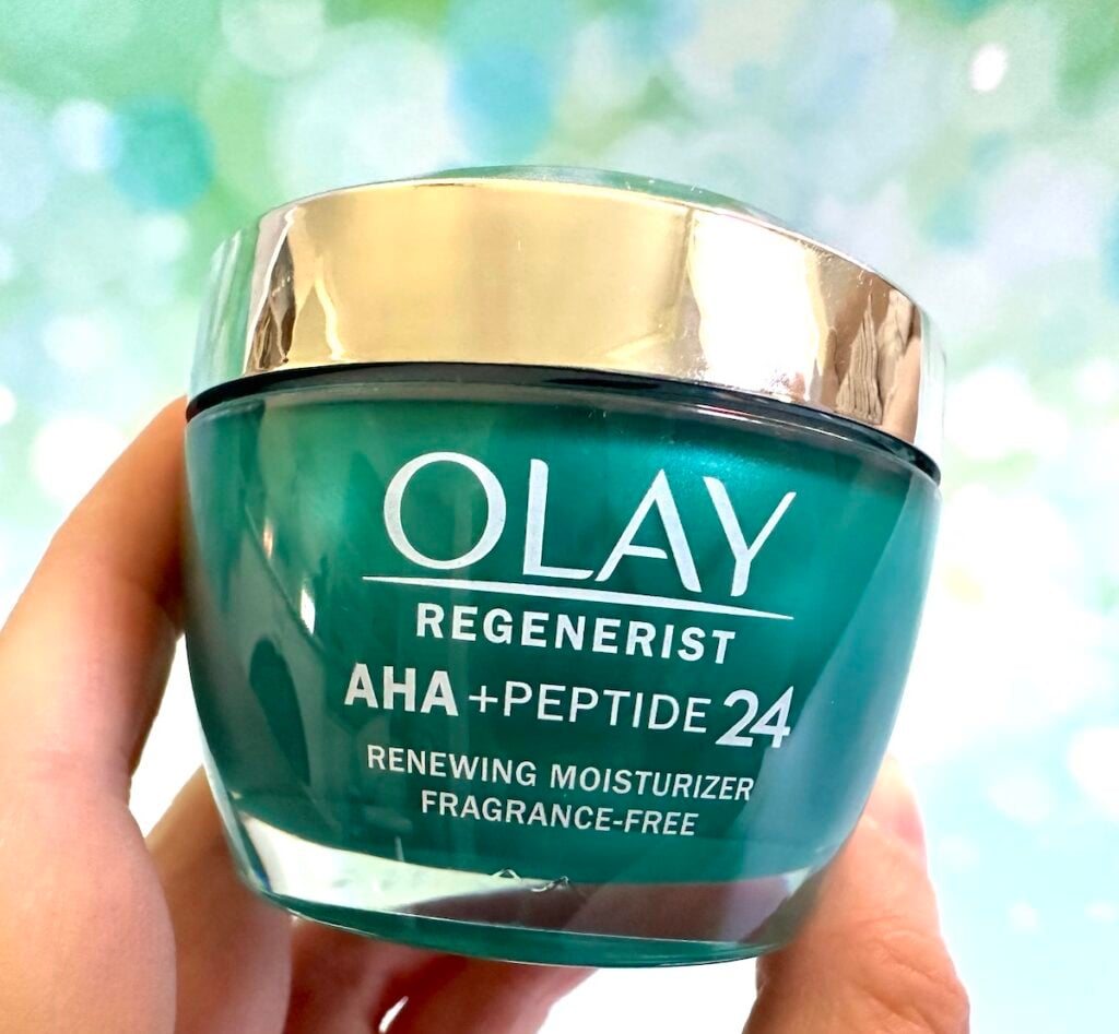 Olay AHA + Peptide 24 Facial Moisturizer, handheld.