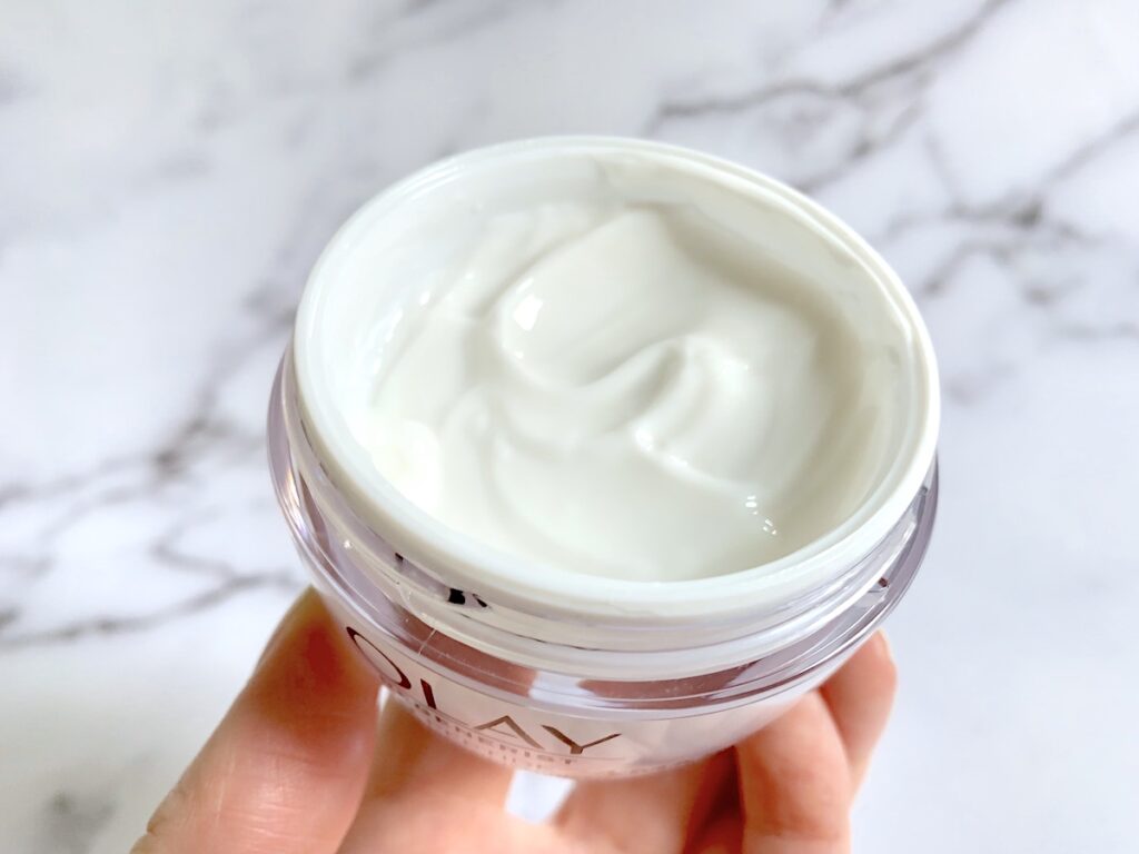 Olay Regenerist Collagen Peptide 24 MAX Moisturizer open jar handheld.