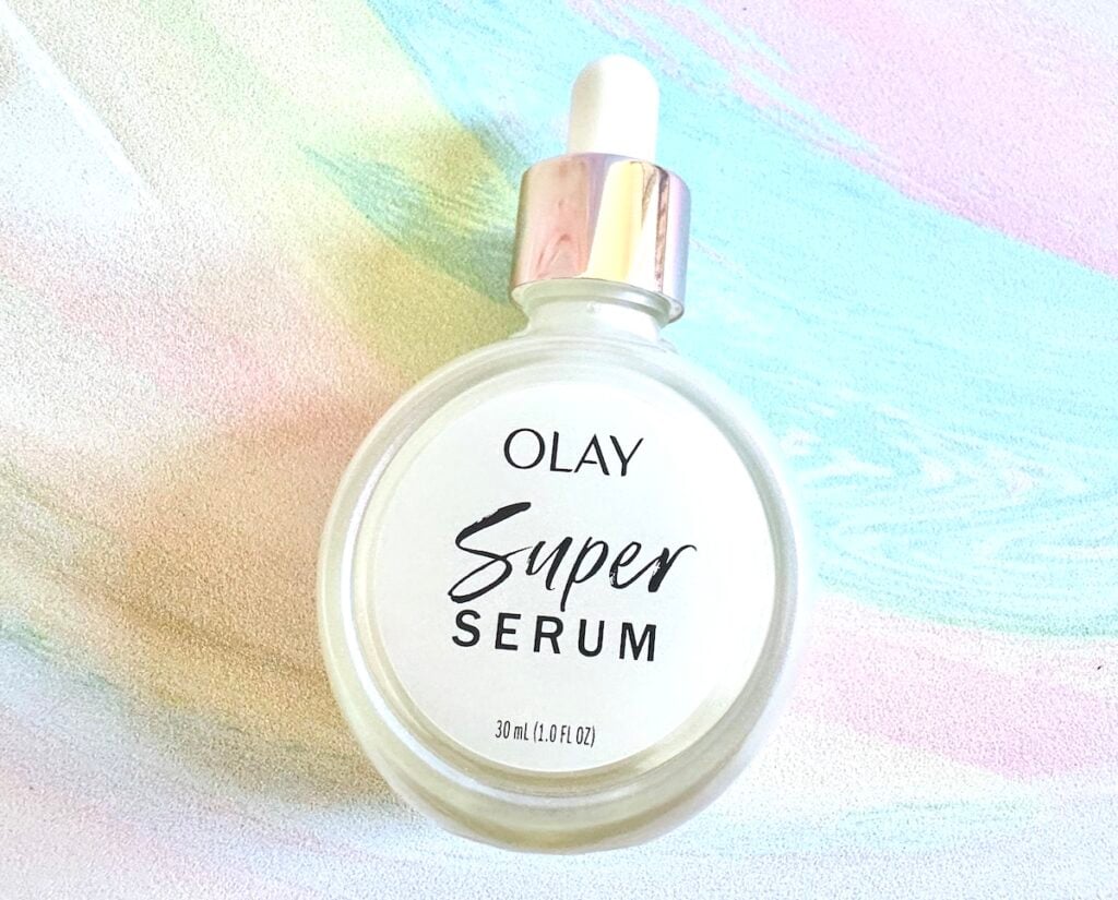 Olay Super Serum, handheld, flatlay.