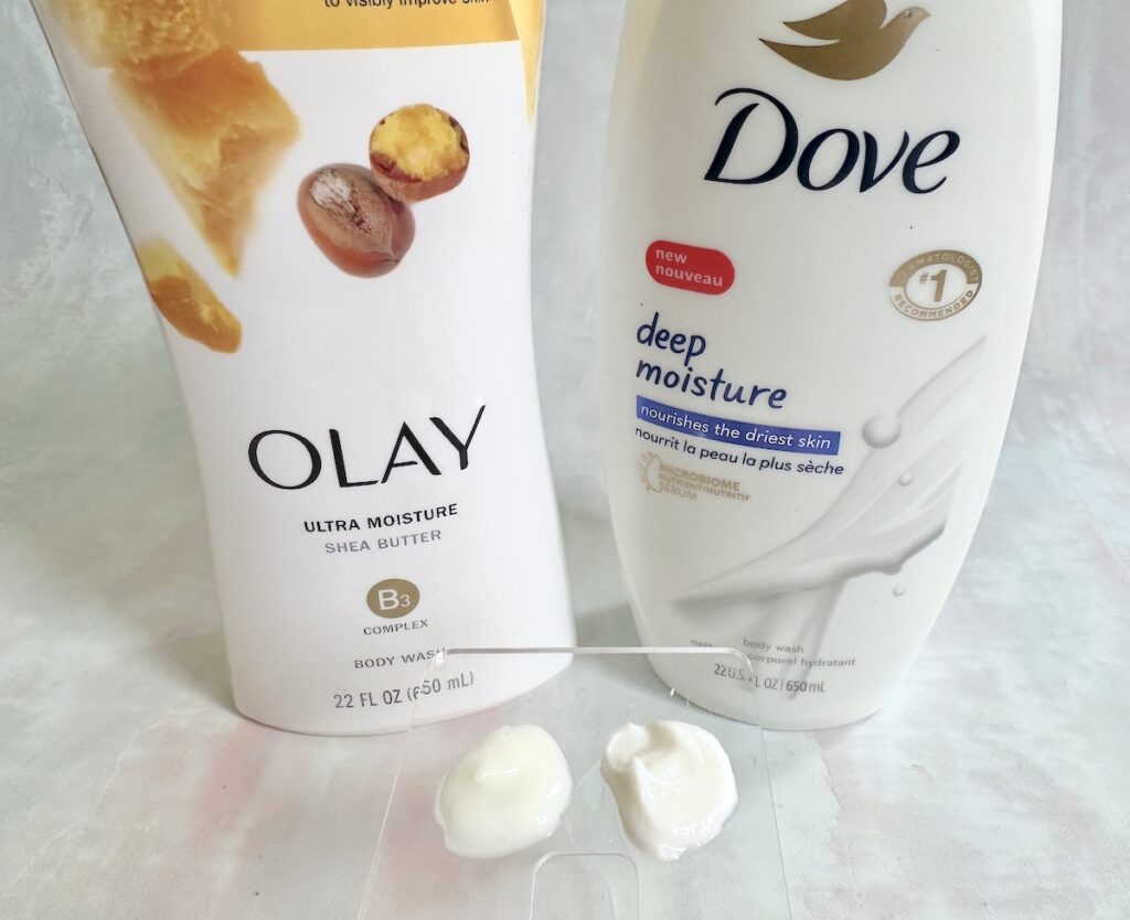 Olay Ultra Moisture Body wash and Dove Deep Moisture Body Wash, sampled on clear spatula.