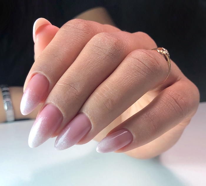 Ombre pink and white frosted nail tips.