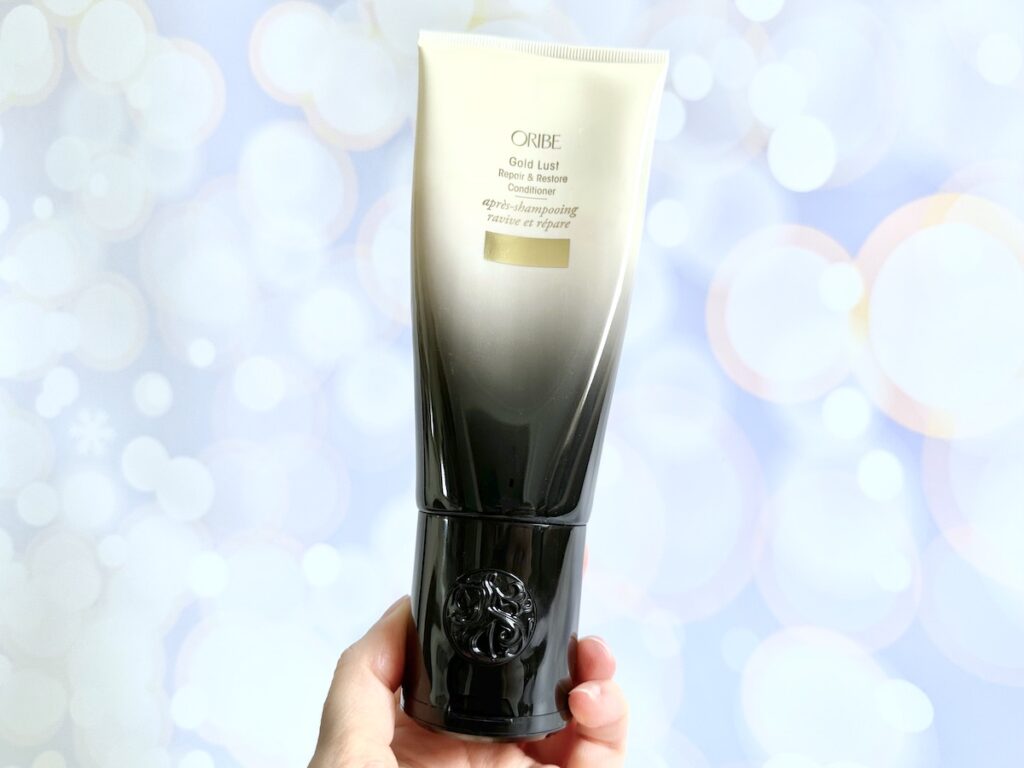 Oribe Gold Lust Repair & Restore Conditioner, handheld.